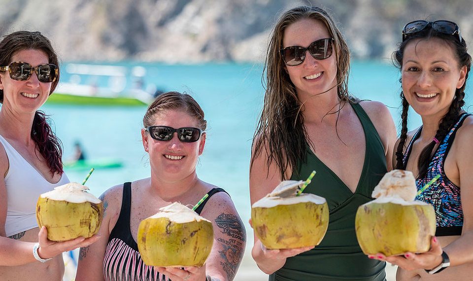 two ladies enjoying a coconut in Tortuga island tour Jaco beach